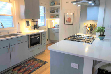 Design ideas for a nautical galley kitchen/diner in Other with a submerged sink, flat-panel cabinets, blue cabinets, engineered stone countertops, stainless steel appliances, light hardwood flooring, no island and brown floors.