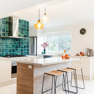 Mid-sized contemporary l-shaped kitchen in Melbourne with an undermount sink, white cabinets, quartz benchtops, porcelain splashback, stainless steel appliances, porcelain floors, with island, beige floor, beige benchtop and flat-panel cabinets.