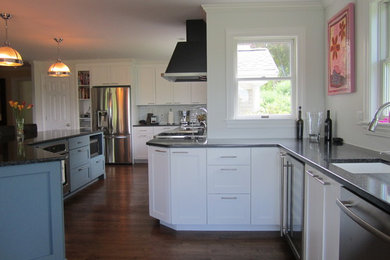 Kitchen - medium tone wood floor kitchen idea in Providence with flat-panel cabinets, quartz countertops and an island