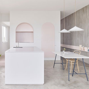 Inspiration for a scandinavian l-shaped eat-in kitchen in Sydney with an undermount sink, flat-panel cabinets, cement tiles, with island and grey floor.