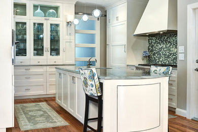 Eat-in kitchen - transitional galley medium tone wood floor eat-in kitchen idea in Charleston with white cabinets, granite countertops, multicolored backsplash, mosaic tile backsplash, stainless steel appliances, an island and recessed-panel cabinets