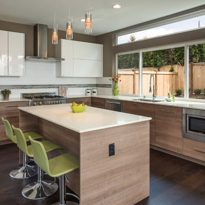 Trendy l-shaped dark wood floor kitchen photo in Seattle with an undermount sink, flat-panel cabinets, medium tone wood cabinets, white backsplash, stainless steel appliances and an island