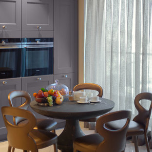 This is an example of a large eclectic l-shaped open plan kitchen in Other with a double-bowl sink, louvered cabinets, purple cabinets, quartz benchtops, beige splashback, stone slab splashback, coloured appliances, ceramic floors, a peninsula, beige floor and beige benchtop.