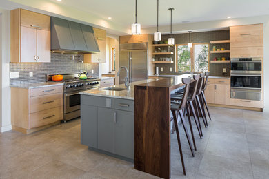 Inspiration for a modern kitchen remodel in Burlington with flat-panel cabinets, light wood cabinets and stainless steel appliances