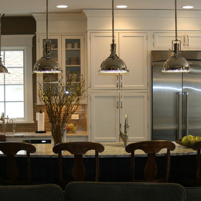 Mid-sized elegant u-shaped medium tone wood floor kitchen pantry photo in Chicago with stainless steel appliances, white cabinets, granite countertops, brown backsplash, glass tile backsplash, an undermount sink, shaker cabinets and an island