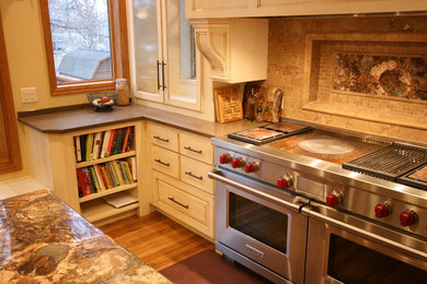 Inspiration for a large transitional u-shaped light wood floor eat-in kitchen remodel in Minneapolis with an undermount sink, raised-panel cabinets, yellow cabinets, onyx countertops, beige backsplash, ceramic backsplash, stainless steel appliances and an island