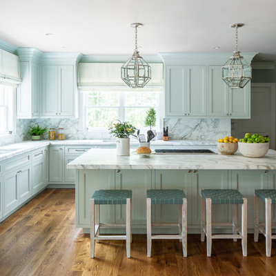 Inspiration for a timeless l-shaped medium tone wood floor kitchen remodel in Denver with an undermount sink, shaker cabinets, blue cabinets, marble countertops, white backsplash, marble backsplash, paneled appliances, an island and white countertops