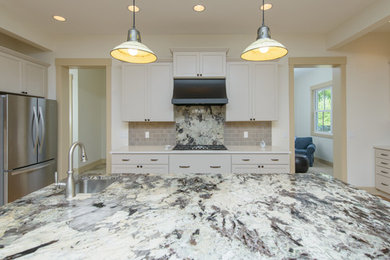Huge country kitchen photo in Baltimore with shaker cabinets, white cabinets, stainless steel appliances and an island