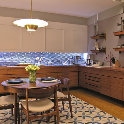 Example of a trendy l-shaped enclosed kitchen design in New York with an undermount sink, flat-panel cabinets, white cabinets, wood countertops, metallic backsplash, ceramic backsplash and stainless steel appliances