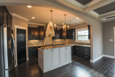 Inspiration for a mid-sized timeless l-shaped dark wood floor and brown floor eat-in kitchen remodel in Other with a double-bowl sink, shaker cabinets, dark wood cabinets, granite countertops, multicolored backsplash, stone tile backsplash, stainless steel appliances and an island