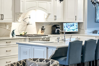 Example of a large transitional l-shaped light wood floor and brown floor open concept kitchen design in New York with a farmhouse sink, beaded inset cabinets, white cabinets, marble countertops, white backsplash, marble backsplash, stainless steel appliances, an island and white countertops
