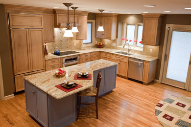 Inspiration for a large transitional u-shaped light wood floor and beige floor eat-in kitchen remodel in Cincinnati with an undermount sink, shaker cabinets, granite countertops, beige backsplash, porcelain backsplash, stainless steel appliances, an island and medium tone wood cabinets