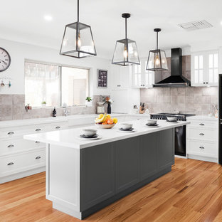 Inspiration for a large traditional l-shaped eat-in kitchen in Perth with shaker cabinets, white cabinets, black appliances, medium hardwood floors, brown floor, white benchtop, a farmhouse sink, beige splashback, with island, quartz benchtops and ceramic splashback.