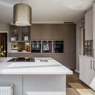 Foto de cocina comedor minimalista con armarios estilo shaker, puertas de armario grises, encimera de cuarcita, salpicadero metalizado, salpicadero de piedra caliza, suelo de travertino y encimeras amarillas