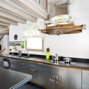 Design ideas for an eclectic kitchen in Moscow with a double-bowl sink, flat-panel cabinets, stainless steel cabinets, with island, white splashback and black appliances.