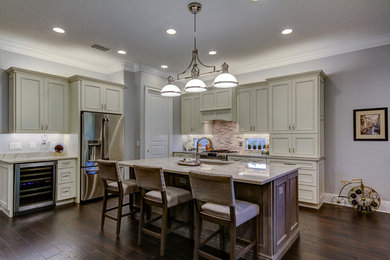 Example of a mid-sized eat-in kitchen design in Tampa with white cabinets, quartzite countertops, an island and recessed-panel cabinets