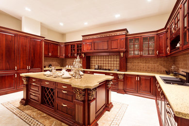 Contemporary kitchen in Phoenix with a built-in sink, raised-panel cabinets, dark wood cabinets, granite worktops, an island and beige worktops.