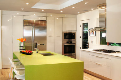 Eat-in kitchen - contemporary u-shaped light wood floor eat-in kitchen idea in DC Metro with an undermount sink, flat-panel cabinets, white cabinets, stainless steel appliances, an island, solid surface countertops, white backsplash and green countertops