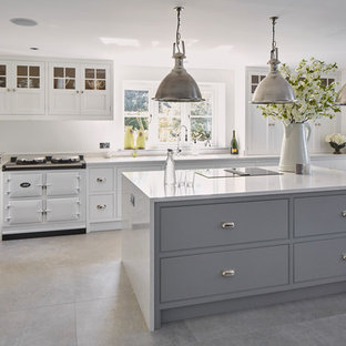 Medium sized classic single-wall kitchen in Oxfordshire with flat-panel cabinets, grey cabinets, white appliances, an island, grey floors and white worktops.
