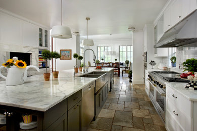 Inspiration for a large transitional galley multicolored floor eat-in kitchen remodel in Chicago with a farmhouse sink, recessed-panel cabinets, white cabinets, marble countertops, gray backsplash, stone slab backsplash, stainless steel appliances and an island