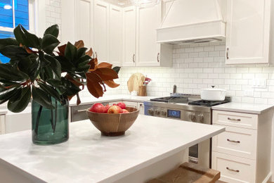 Inspiration for a mid-sized contemporary u-shaped enclosed kitchen remodel in New York with shaker cabinets, white cabinets, quartz countertops, an island and gray countertops