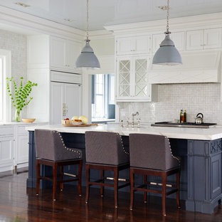 Inspiration for a large coastal dark wood floor kitchen remodel in Jacksonville with recessed-panel cabinets, white cabinets, beige backsplash, mosaic tile backsplash, paneled appliances and an island