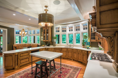 Eat-in kitchen - large craftsman u-shaped medium tone wood floor and brown floor eat-in kitchen idea in Other with an undermount sink, recessed-panel cabinets, distressed cabinets, stainless steel appliances, an island, solid surface countertops and white backsplash