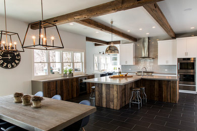 Inspiration for a large craftsman u-shaped porcelain tile and black floor open concept kitchen remodel in Other with an undermount sink, an island, flat-panel cabinets, white cabinets, solid surface countertops, gray backsplash and gray countertops