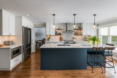 Inspiration for a transitional medium tone wood floor kitchen remodel in Ottawa with an undermount sink, shaker cabinets, white cabinets, gray backsplash, stainless steel appliances, an island and gray countertops
