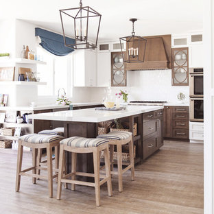 Coastal kitchen pictures - Inspiration for a coastal l-shaped light wood floor and beige floor kitchen remodel in San Diego with shaker cabinets, medium tone wood cabinets, white backsplash, an island and white countertops