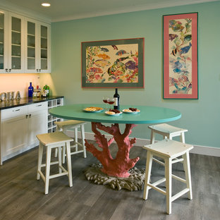 This is an example of a tropical kitchen in Hawaii with glass-front cabinets, white cabinets, granite benchtops, vinyl floors and with island.