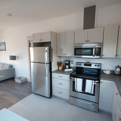 Inspiration for a small contemporary l-shaped eat-in kitchen remodel in Other with a drop-in sink, recessed-panel cabinets, gray cabinets, laminate countertops, stainless steel appliances and no island