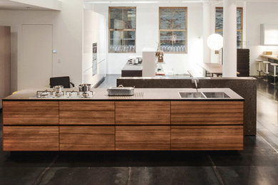 Foto de cocina minimalista con armarios abiertos, puertas de armario de madera oscura y encimera de acrílico