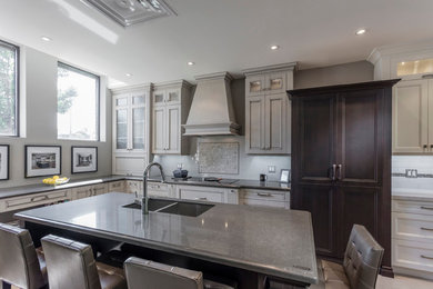 Mid-sized elegant l-shaped kitchen photo in Toronto with beige cabinets and an island