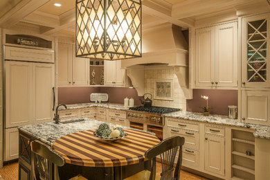Eat-in kitchen - mid-sized traditional l-shaped cork floor eat-in kitchen idea in Other with beaded inset cabinets, white cabinets, granite countertops, paneled appliances and an island