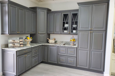 Inspiration for a small timeless l-shaped eat-in kitchen remodel in Other with raised-panel cabinets, gray cabinets and no island