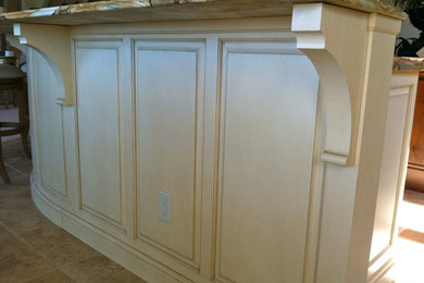 Example of a beach style kitchen design in Grand Rapids with beige cabinets and granite countertops