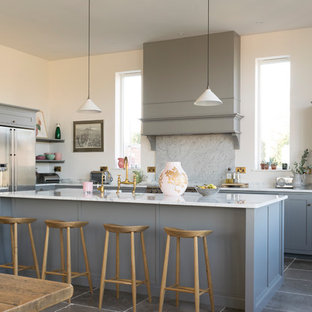 Photo of a large classic l-shaped open plan kitchen in Other with shaker cabinets, grey cabinets, quartz worktops, white splashback, marble splashback, stainless steel appliances, limestone flooring, an island and grey floors.
