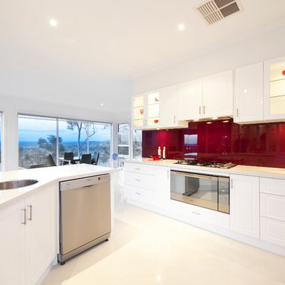 Inspiration for a contemporary eat-in kitchen remodel in Melbourne with a drop-in sink, white cabinets, red backsplash and stainless steel appliances