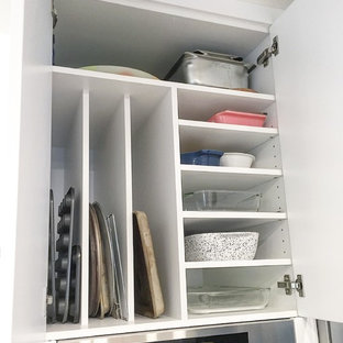 Design ideas for a mid-sized scandinavian l-shaped open plan kitchen in Edmonton with an undermount sink, flat-panel cabinets, white cabinets, multi-coloured splashback, mosaic tile splashback, stainless steel appliances, ceramic floors and with island.