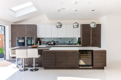 This is an example of a medium sized contemporary single-wall kitchen/diner in London with an island.