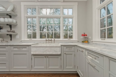 Large danish l-shaped medium tone wood floor eat-in kitchen photo in Chicago with a farmhouse sink, beaded inset cabinets, gray cabinets, marble countertops, metallic backsplash, metal backsplash, stainless steel appliances and an island