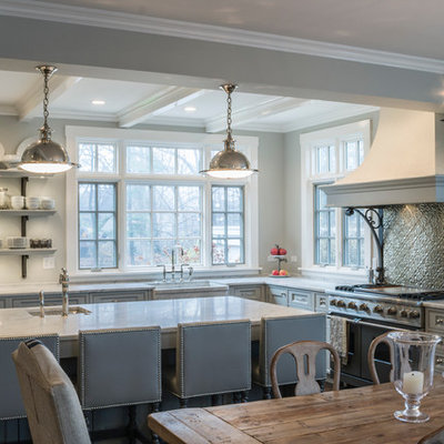 Large elegant l-shaped eat-in kitchen photo in Chicago with a farmhouse sink, stainless steel appliances, beaded inset cabinets, gray cabinets, marble countertops, metallic backsplash, metal backsplash, an island and gray countertops