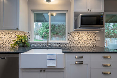 Inspiration for a contemporary galley kitchen in Seattle with shaker cabinets, white cabinets, engineered stone countertops, grey splashback, laminate floors, grey floors and blue worktops.