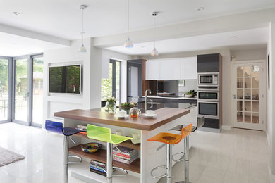 Inspiration for a large contemporary l-shaped open plan kitchen in Cheshire with integrated appliances.