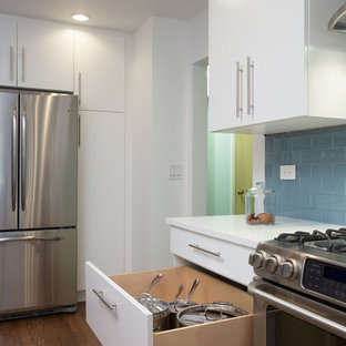 Design ideas for a mid-sized modern galley eat-in kitchen in Chicago with an undermount sink, flat-panel cabinets, white cabinets, copper benchtops, blue splashback, subway tile splashback, stainless steel appliances, medium hardwood floors and no island.