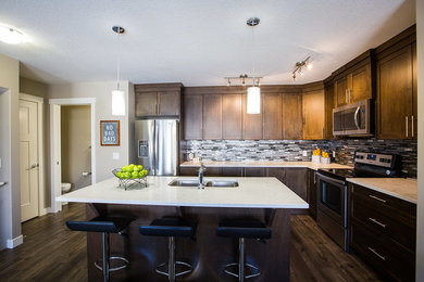 Example of a transitional kitchen design in Calgary