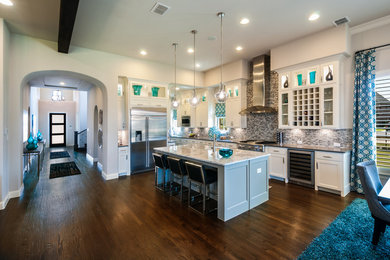 Open concept kitchen - large contemporary single-wall dark wood floor and brown floor open concept kitchen idea in Dallas with an undermount sink, gray backsplash, matchstick tile backsplash, stainless steel appliances, shaker cabinets, white cabinets, granite countertops and an island