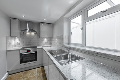 Sleek Grey Kitchen with Stone Tiled Floors