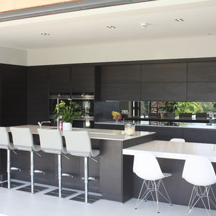 Inspiration for a mid-sized modern l-shaped open concept kitchen remodel in Other with flat-panel cabinets, quartzite countertops, metallic backsplash, mirror backsplash, stainless steel appliances and two islands